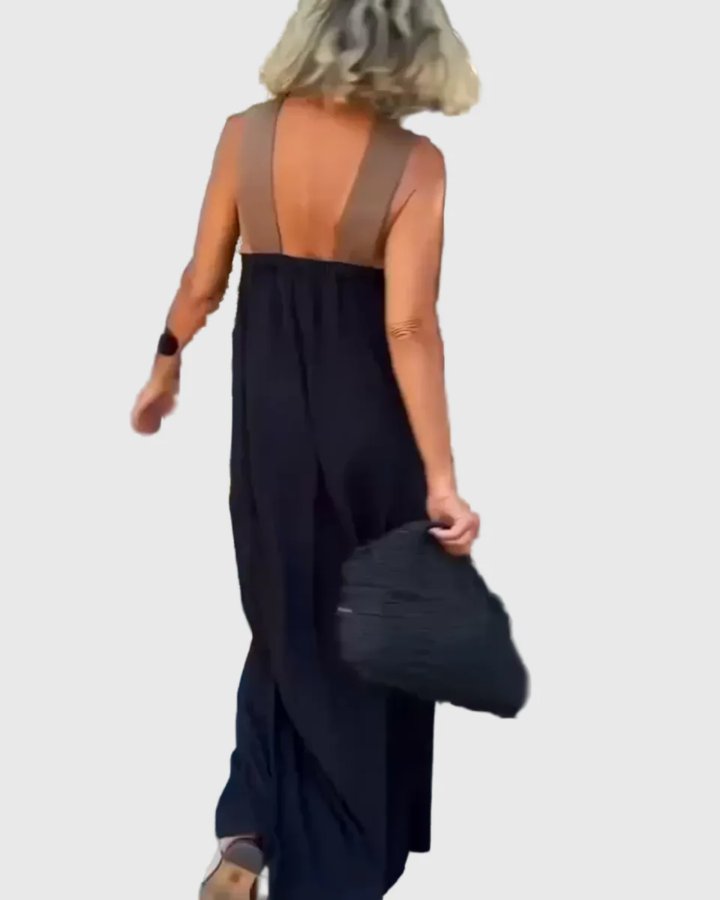 Woman wearing a long flowing maxi dress with a flattering crossover neckline.