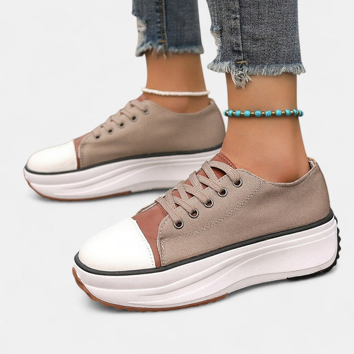 A woman in platform comfort sneakers giving a flattering little lift.