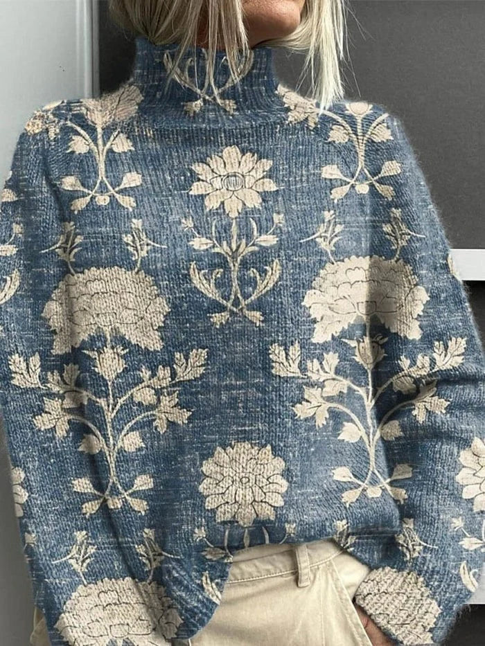 A woman in a green roll-neck sweater with a woodland print of animals, birds and toadstools.