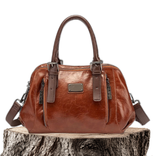 A woman carrying a structured luxury handbag on her arm as she walks through town.