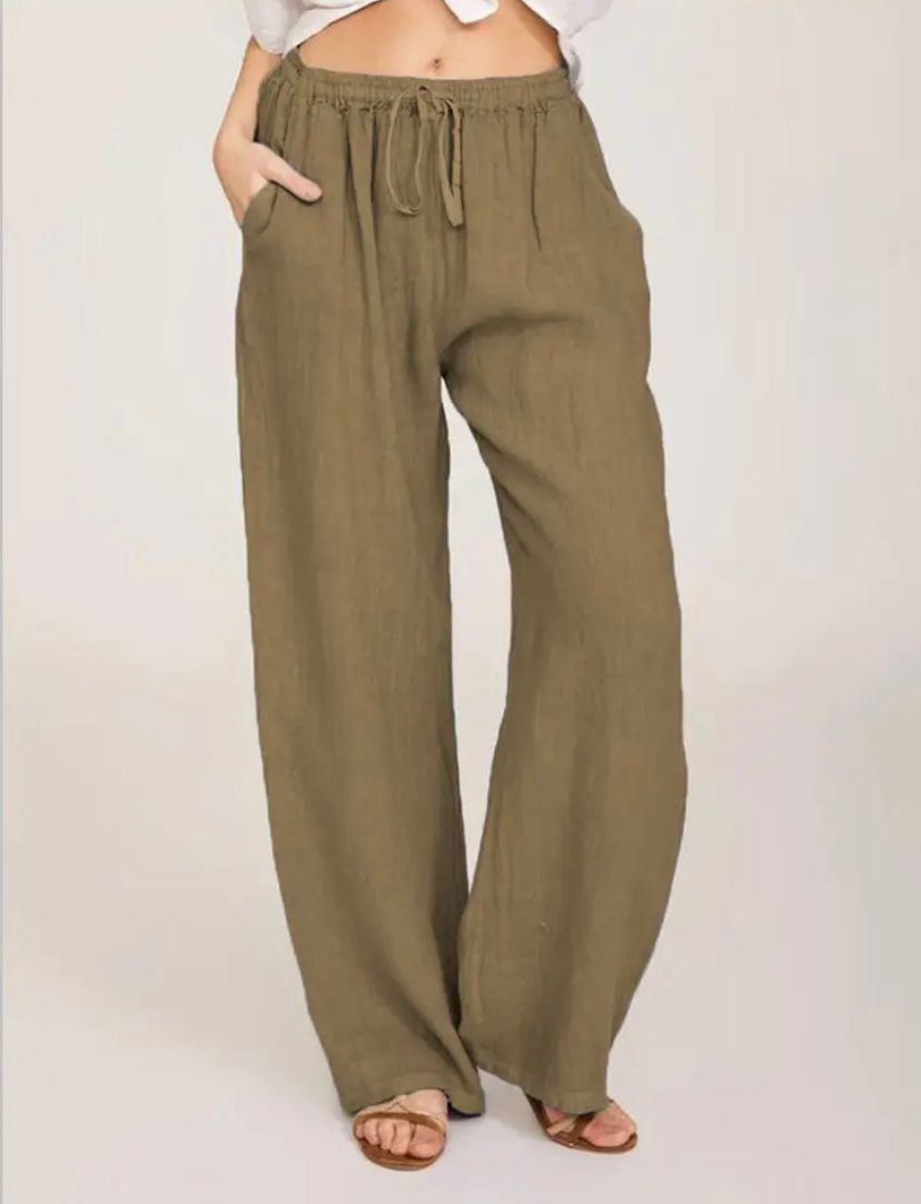 Woman wearing lightweight summer pants with a light blouse, walking on a warm day.