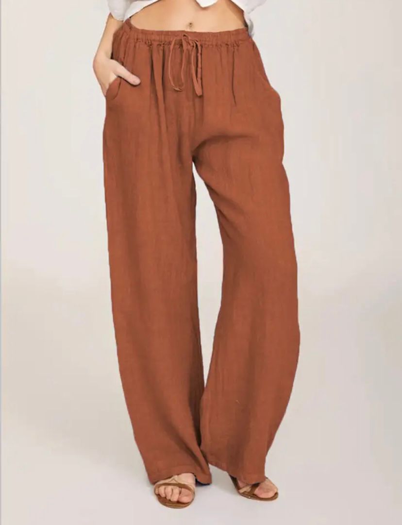 Woman wearing lightweight summer pants with a light blouse, walking on a warm day.
