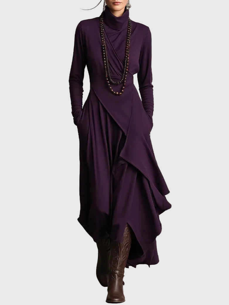 Woman wearing the Nancy draped high-neck maxi dress in violet with ankle boots.