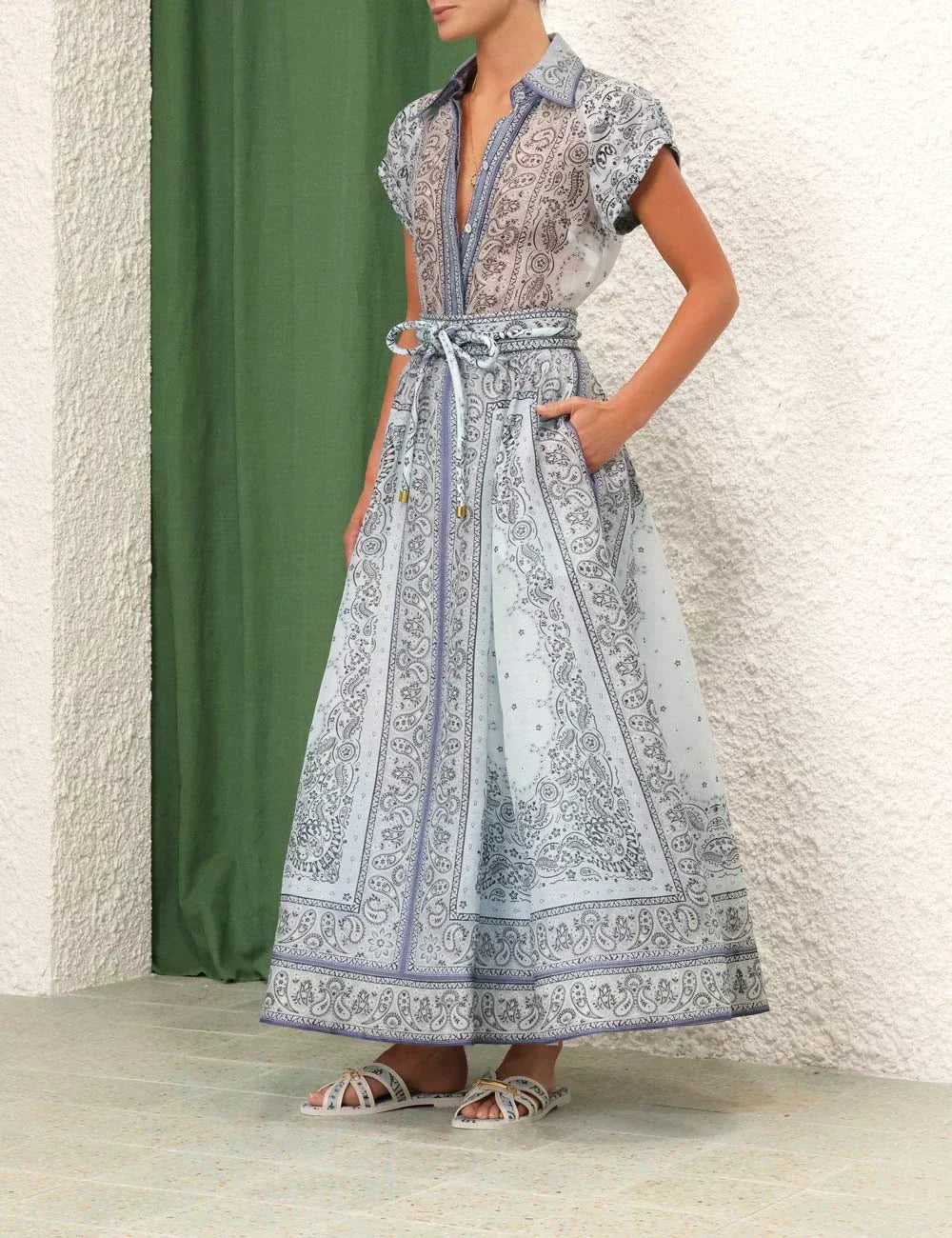 A woman wearing a boho-print top with a flowing midi skirt