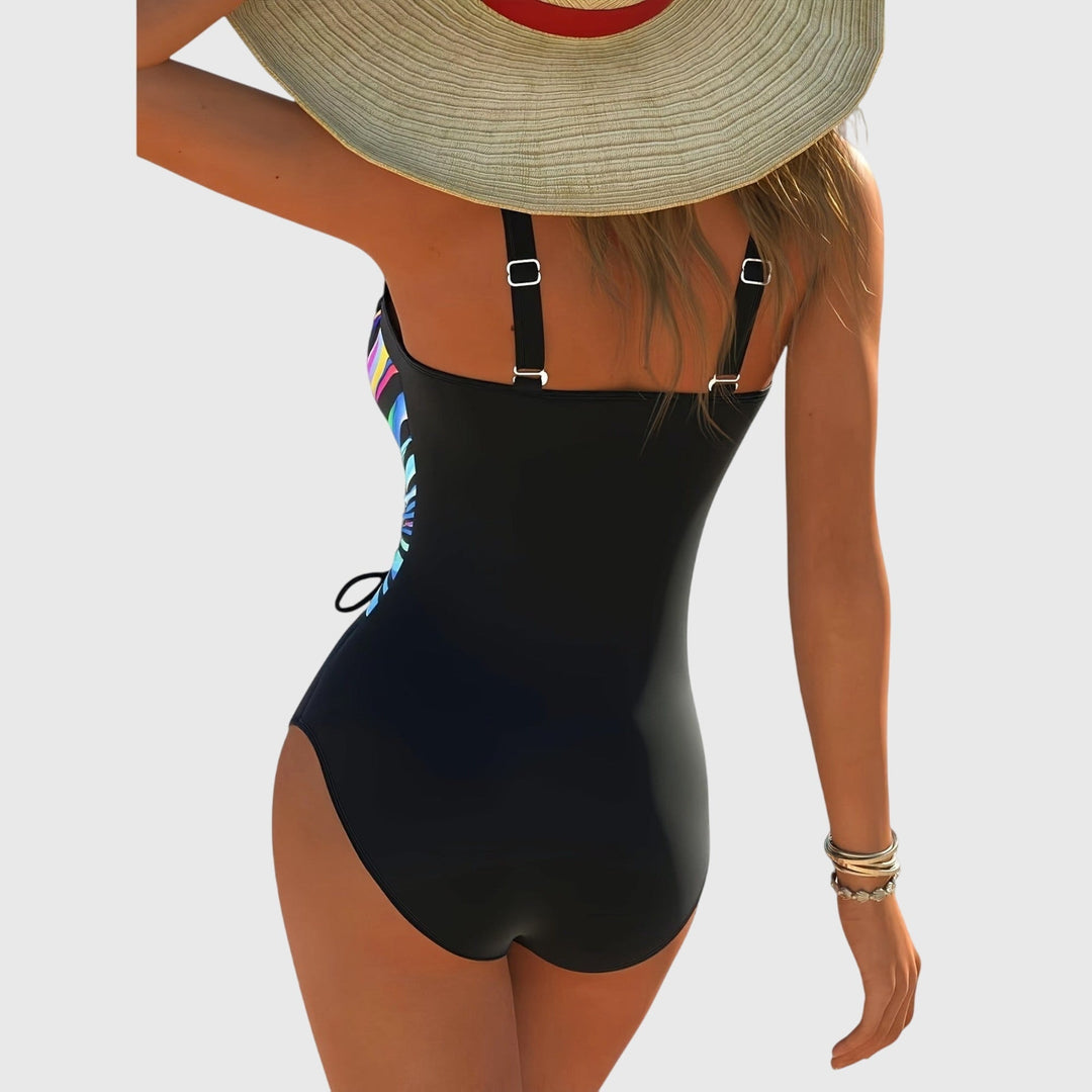 A woman by the pool in a cross-front shaping swimsuit, confident and relaxed in the sun.