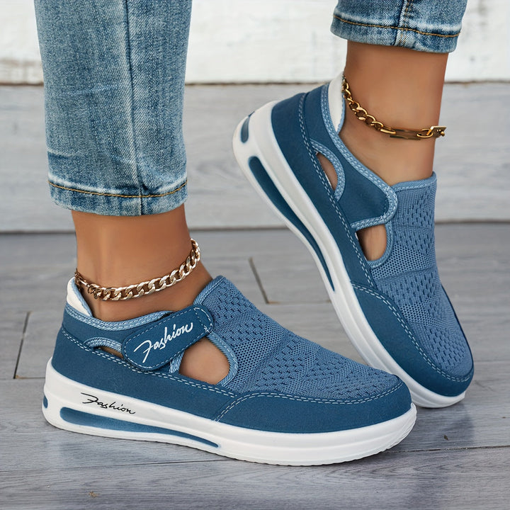 A woman slipping on breathable, cushioned slip-on sneakers with pants