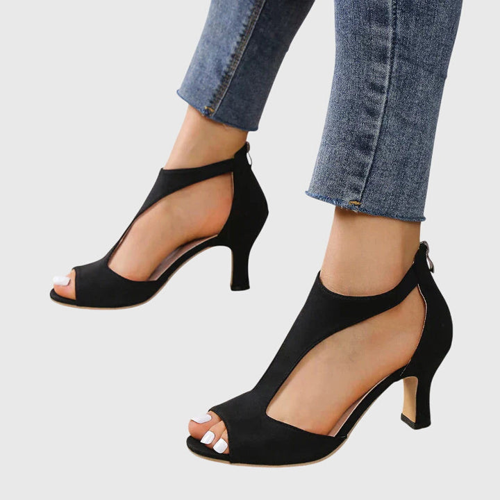 A woman in soft pink supportive heels walking with ease through her day.