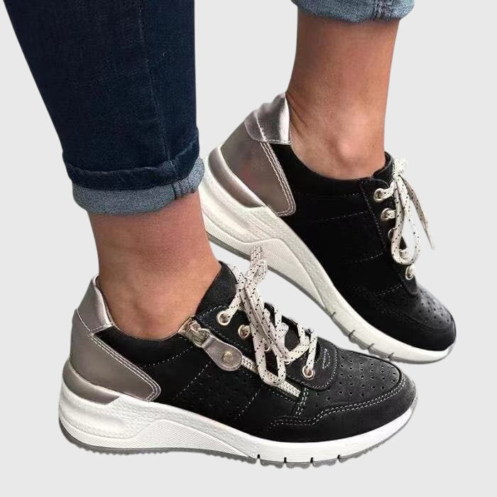 A woman on a walk wearing soft, supportive sneakers on a bright day.