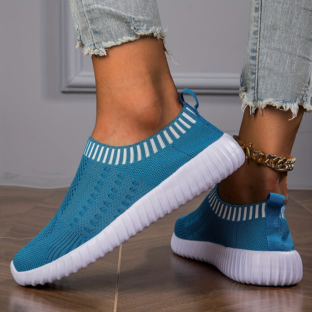 A woman slipping on ultralight sock-style sneakers that hug the foot.