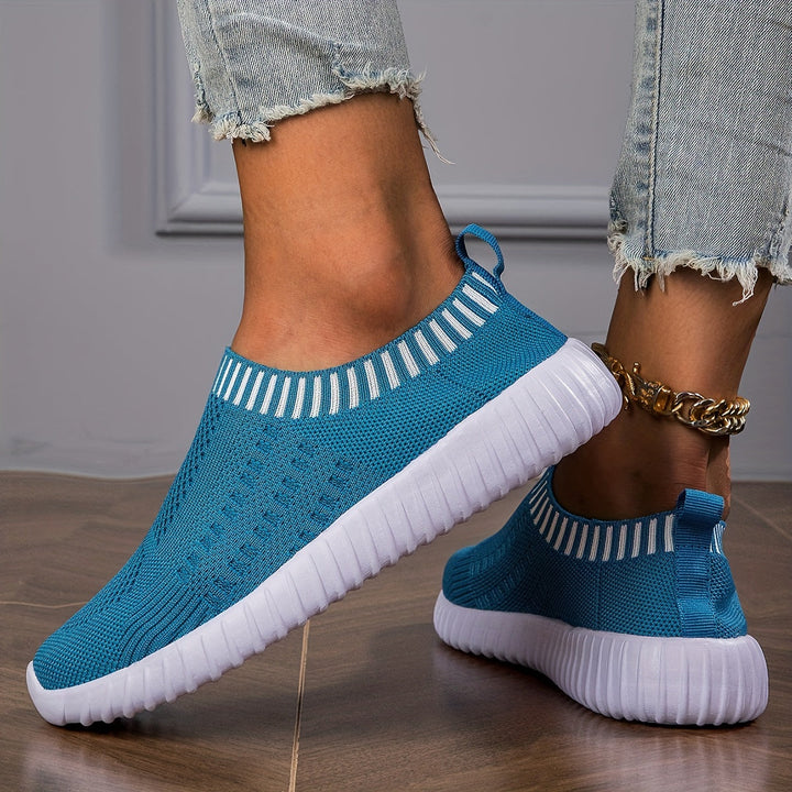 A woman slipping on ultralight sock-style sneakers that hug the foot.