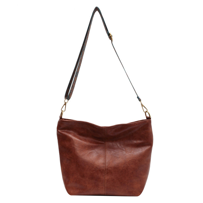 A woman carrying a vintage-style bag with a shoulder strap on a day out