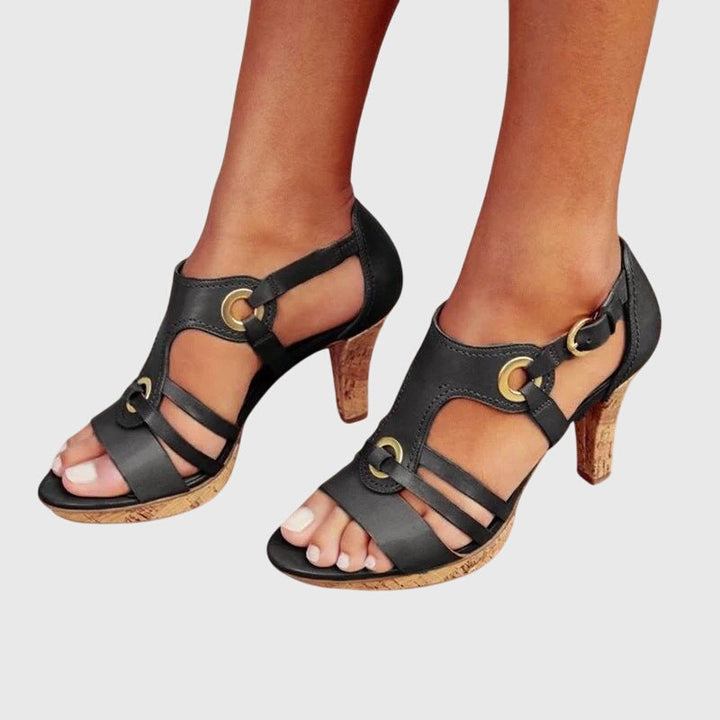 A woman in supportive heeled sandals standing comfortably at a summer event.