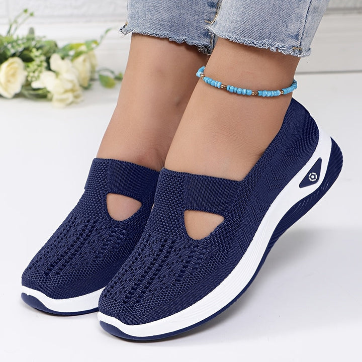 A woman stepping into easy slip-on comfort sneakers with no laces.
