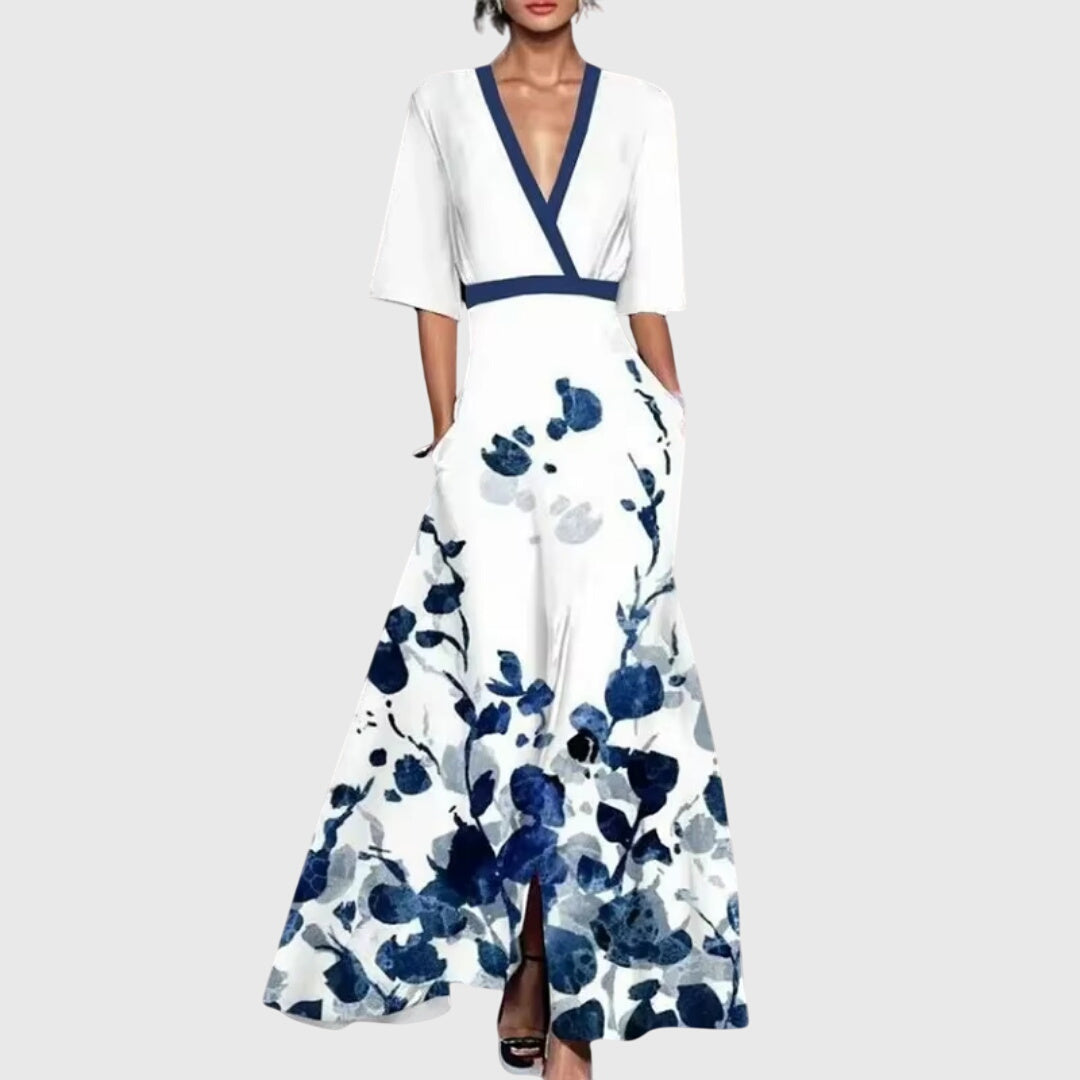 Woman wearing a light floral spring dress with a defined waist and a softly swinging skirt.