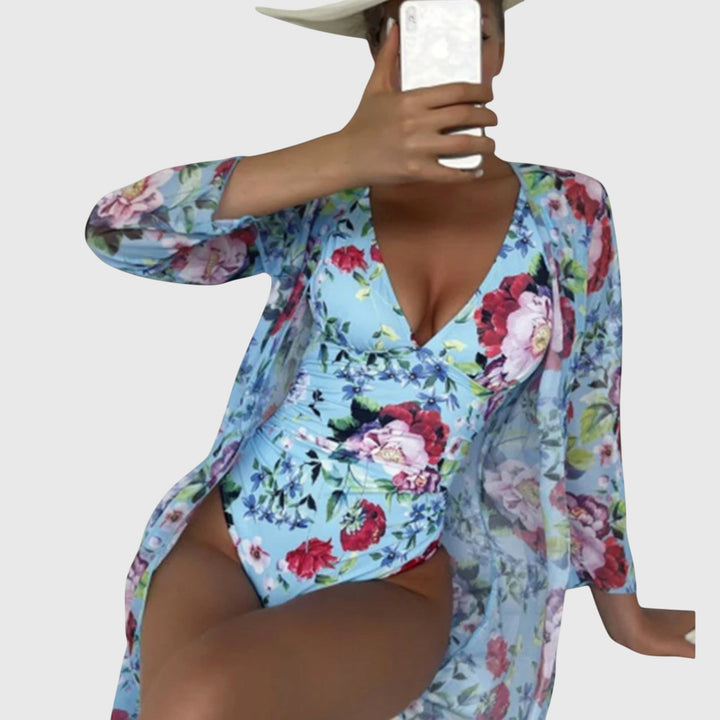 A woman relaxing by the pool in an airy printed swimsuit, glowing and carefree in the summer sun.