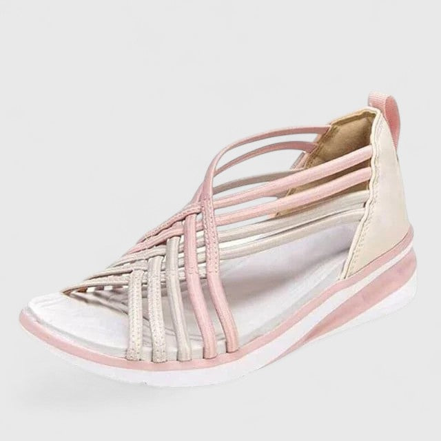 A woman walking comfortably in wide-fit multi-strap orthopaedic sandals with an open design.