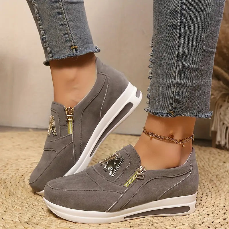 A woman wearing cushioned side-zip sneakers with a relaxed everyday outfit