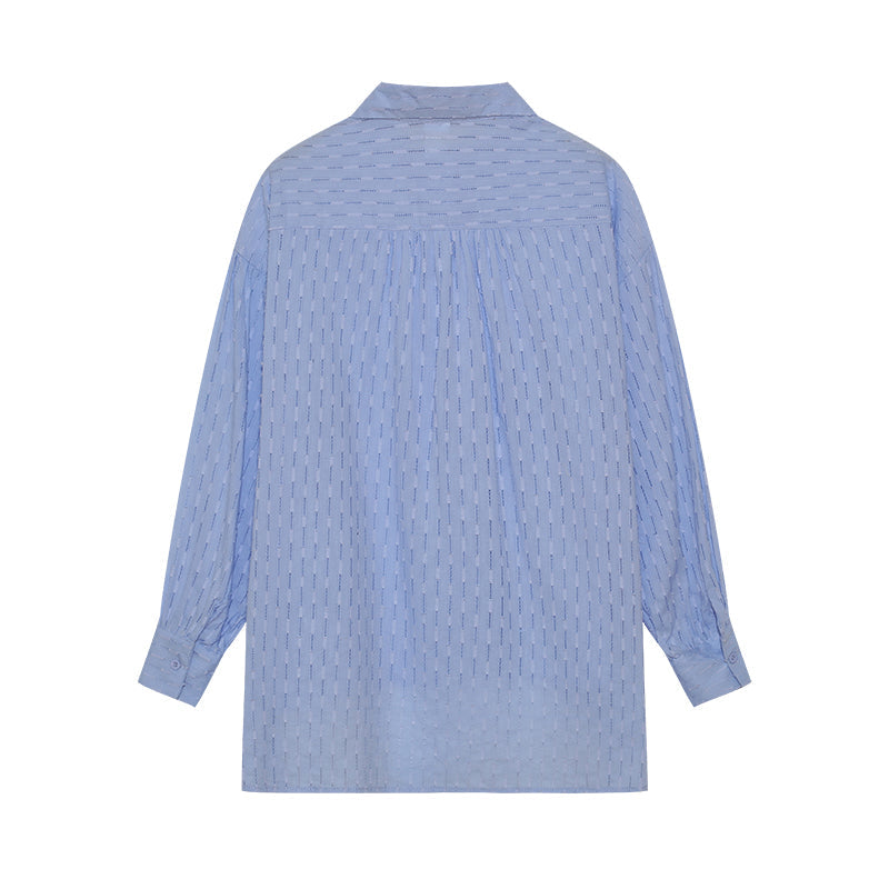A woman wearing a classic button shirt with matching relaxed shorts, polished and easy.