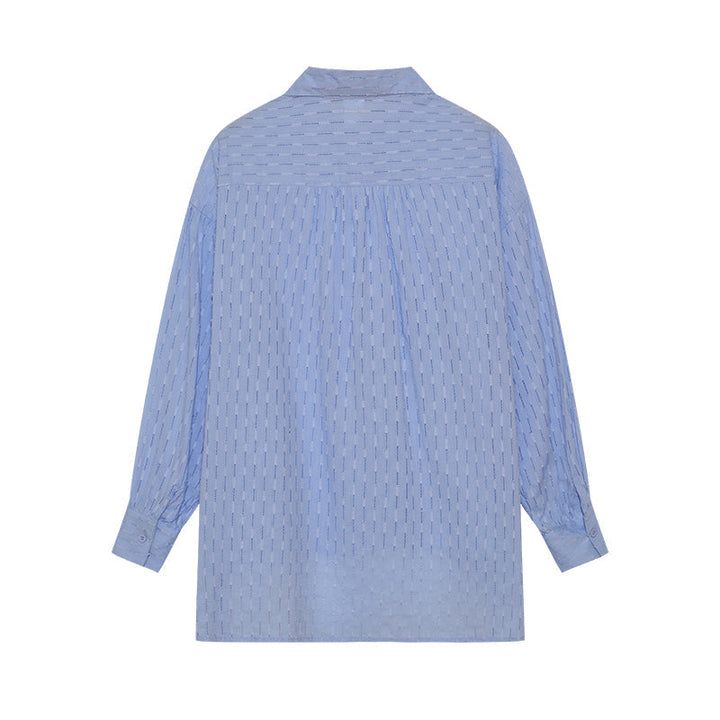 A woman wearing a classic button shirt with matching relaxed shorts, polished and easy.