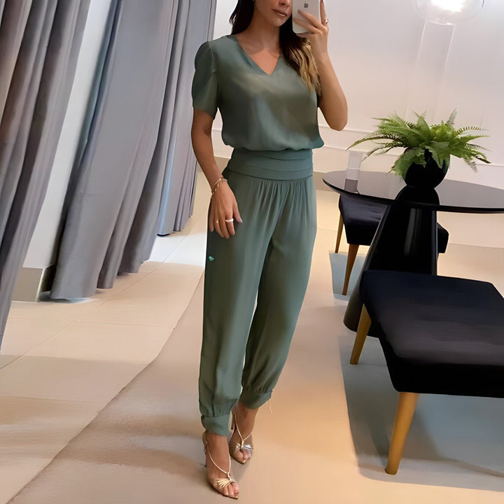 A woman wearing a plain V-neck top with geometric print slim pants, chic and comfortable.