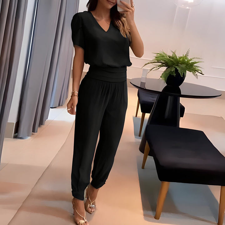 A woman wearing a plain V-neck top with geometric print slim pants, chic and comfortable.