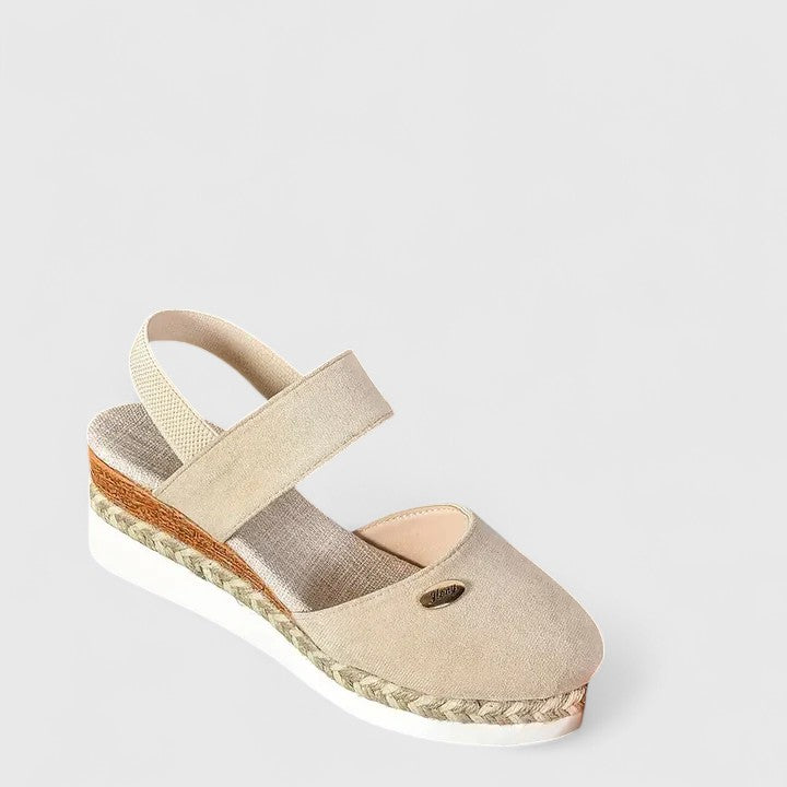 A woman in beige espadrille-inspired sandals stepping out comfortably on a bright morning.