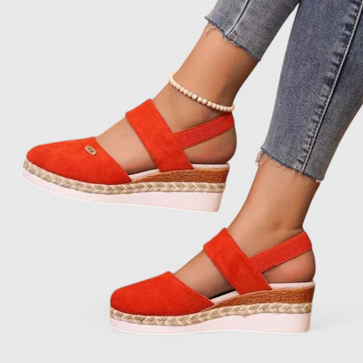 A woman in beige espadrille-inspired sandals stepping out comfortably on a bright morning.