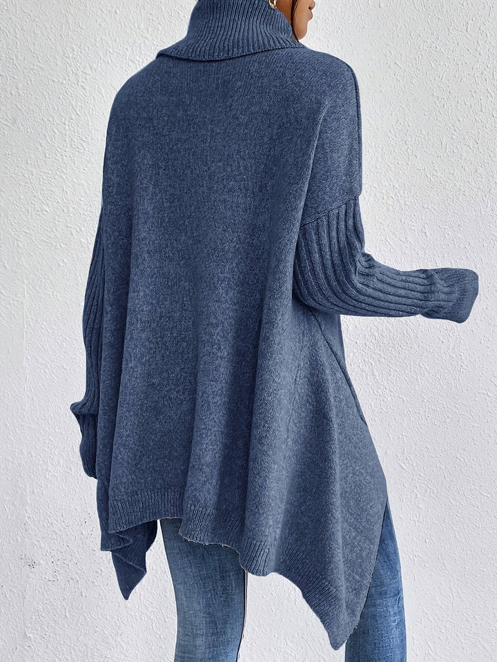 A woman wearing a stand-collar sweater with a chic asymmetric drape, warm and polished.
