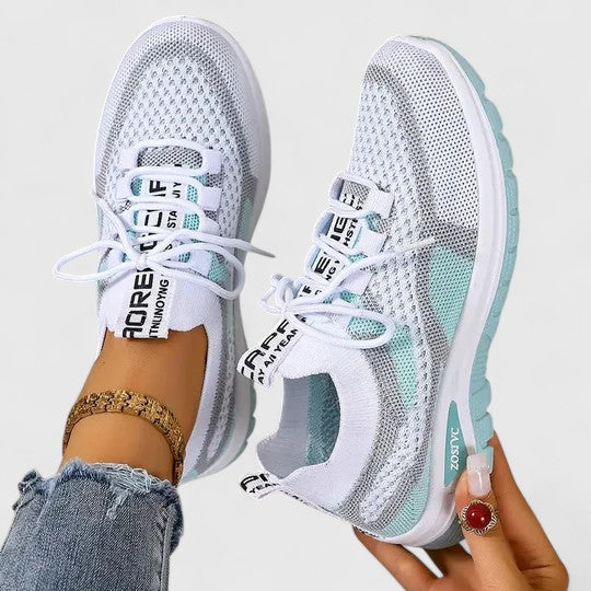 A woman lacing up light, breathable orthopaedic sneakers before a walk.