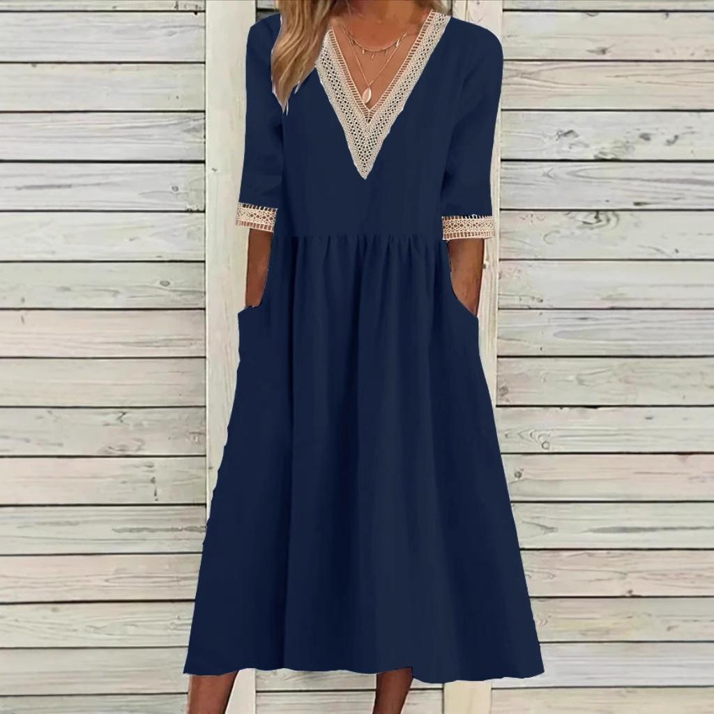 A woman wearing the Anne V-neck midi dress with delicate detailing at the collar and sleeves.
