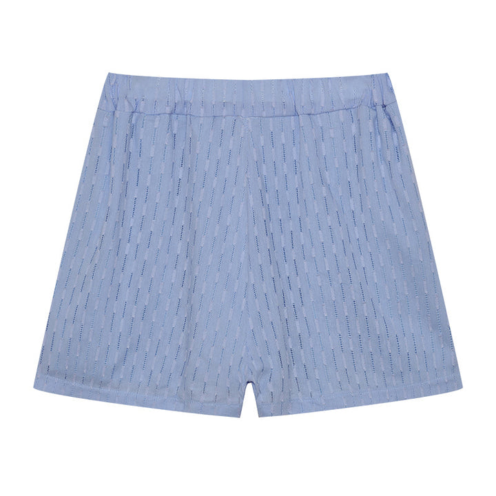 A woman wearing a classic button shirt with matching relaxed shorts, polished and easy.