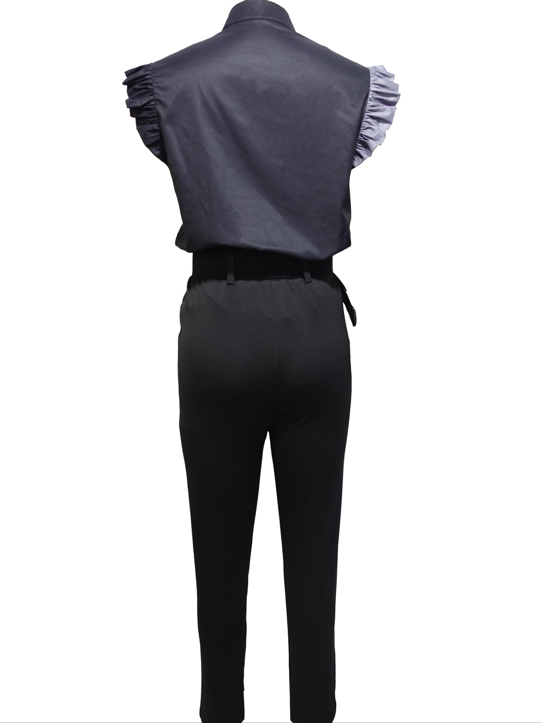 A woman wearing a floral ruffle-sleeve top with high-waisted pants, elegant and striking.