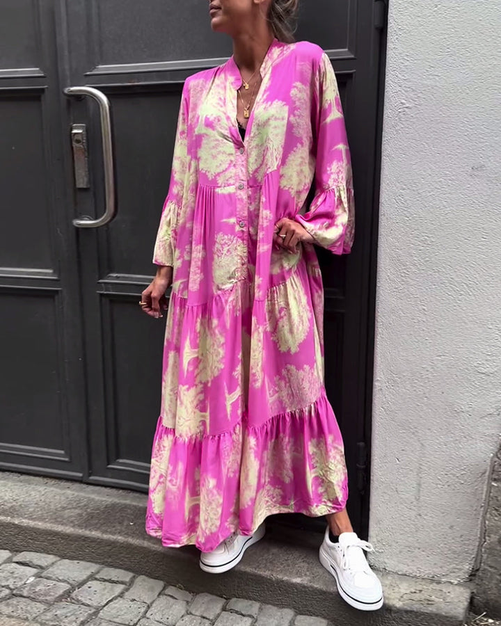 Woman wearing the Sylvie flowing maxi dress with a delicate print and V-neckline, the skirt moving softly as she walks.