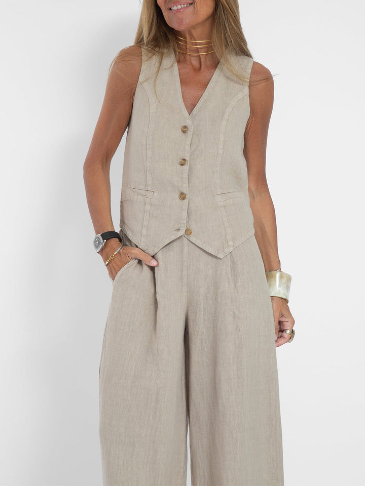 A woman wearing a tailored waistcoat with flowing wide-leg pants