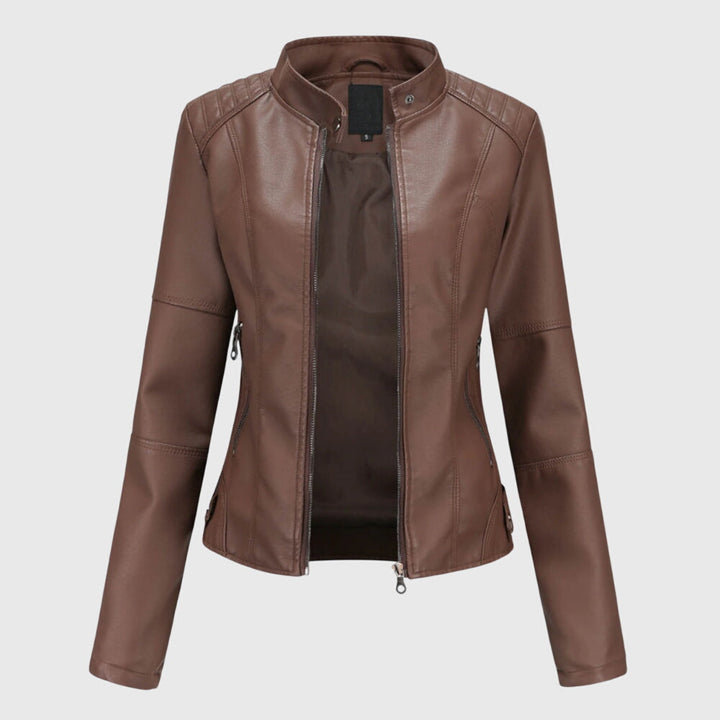 A woman wearing a fitted black moto jacket with a supple finish, styled for an evening out.