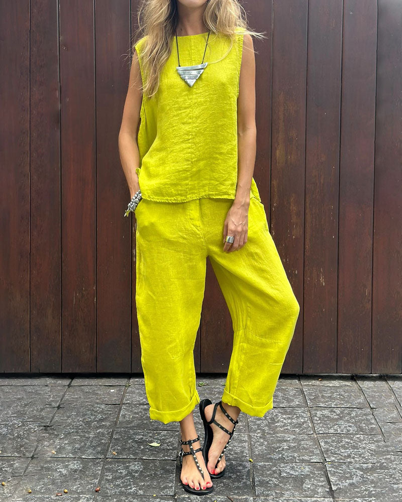 A woman wearing a relaxed sleeveless top with ankle-length pants, easy and elegant.