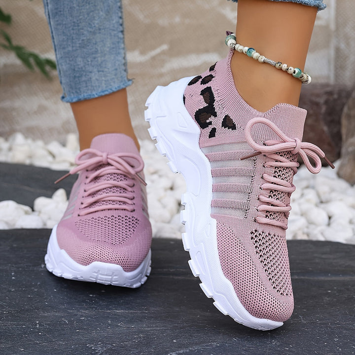 A woman walking in light, breathable comfort sneakers on a warm day.