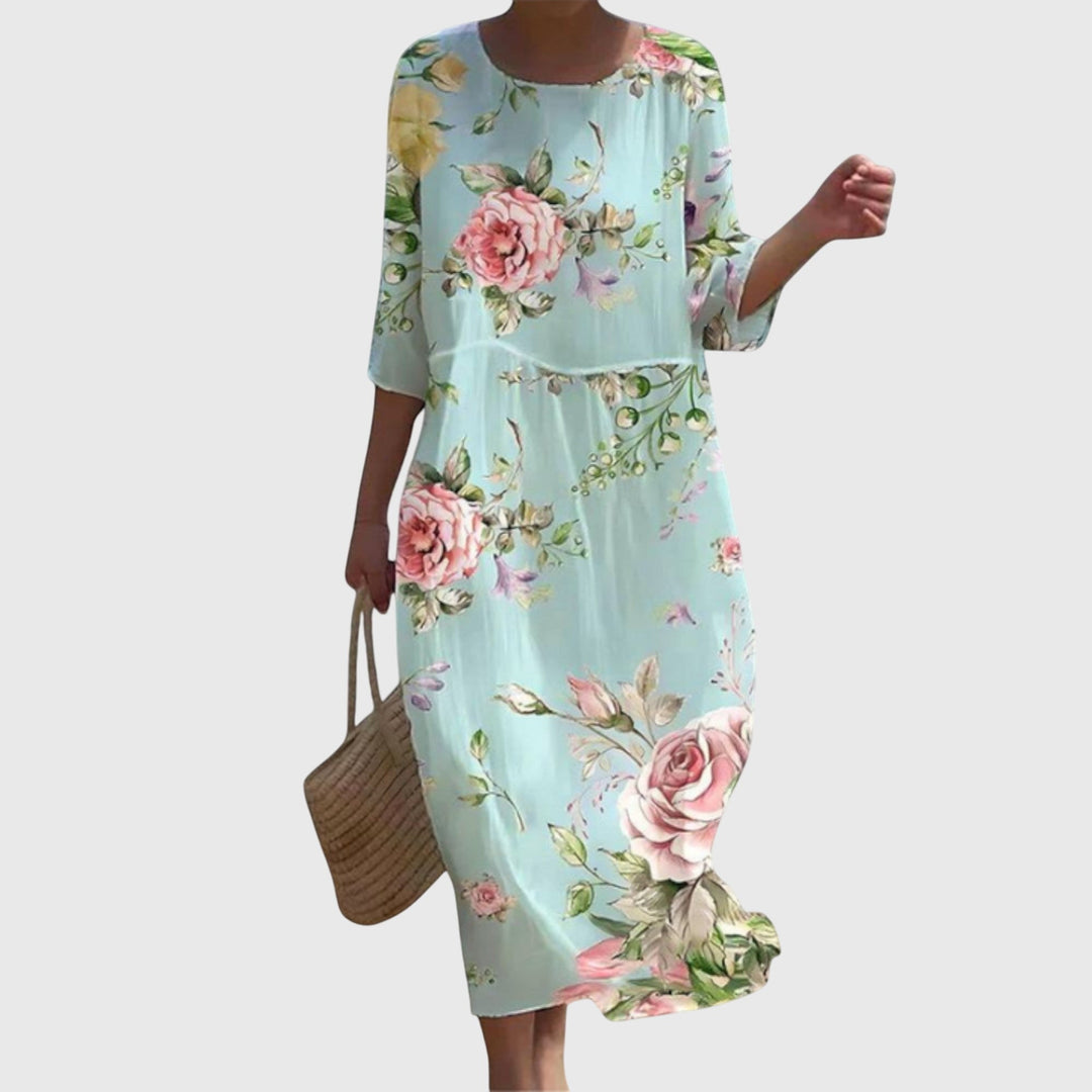 Woman wearing a long flowing maxi dress with a delicate floral print, moving gracefully.