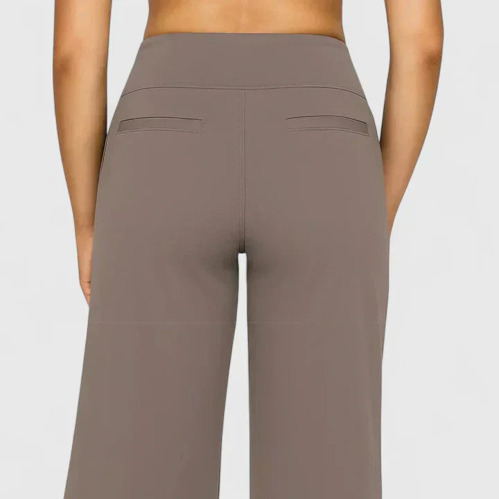 A woman in elegant straight-leg pants with pockets, styled for a polished everyday look.