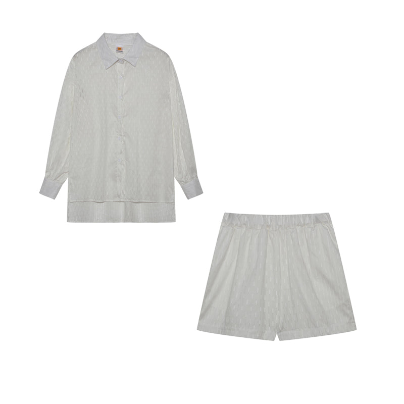 A woman wearing a classic button shirt with matching relaxed shorts, polished and easy.