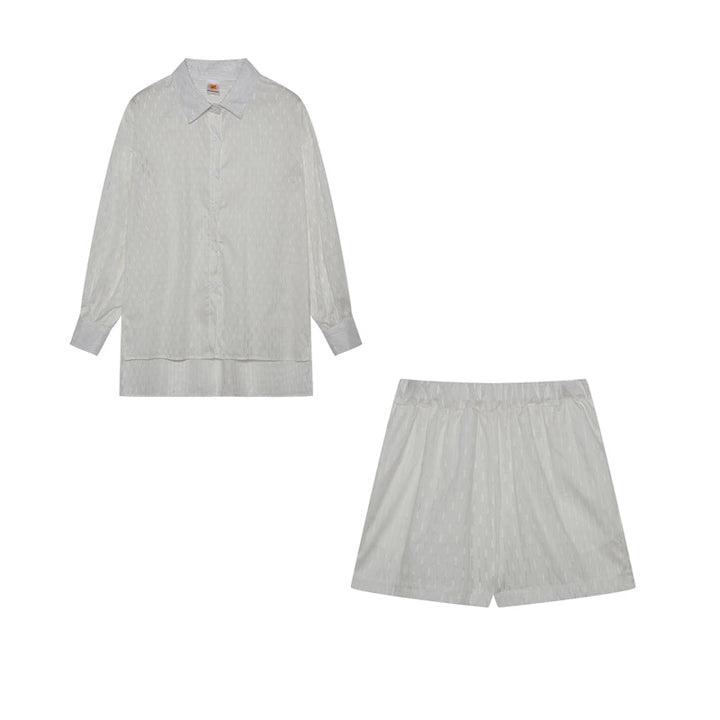 A woman wearing a classic button shirt with matching relaxed shorts, polished and easy.