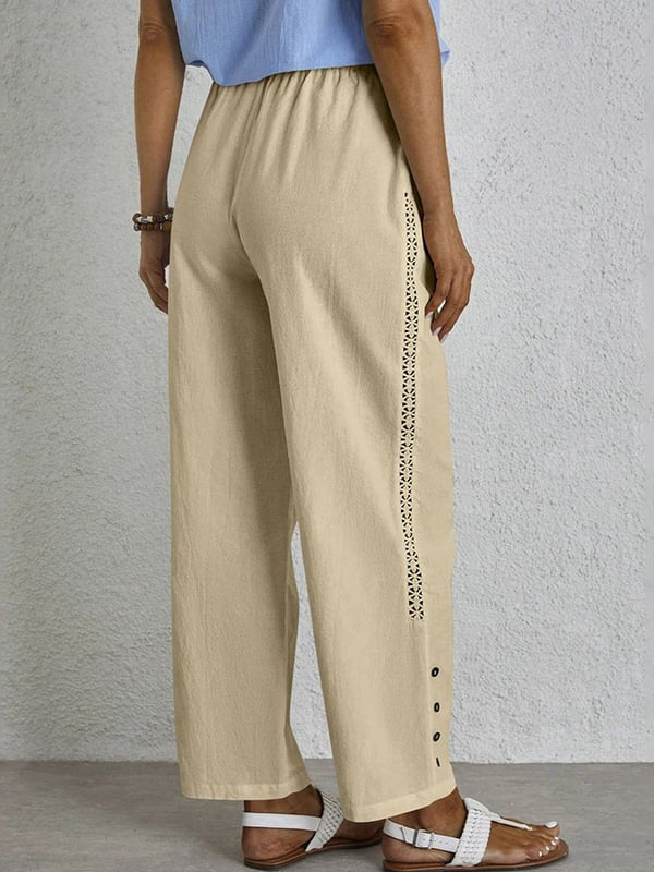 Woman wearing relaxed button-detail pants with a simple top, out for the day.