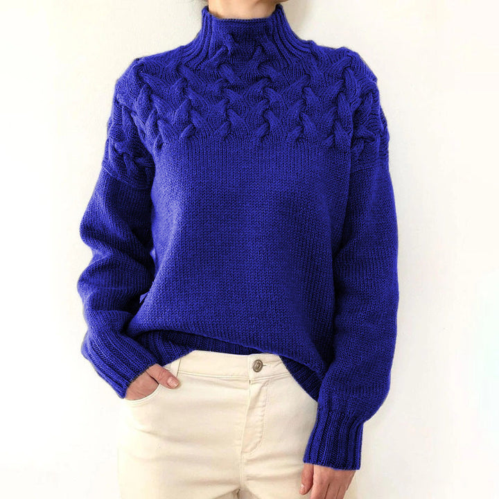 A woman wearing a warm roll-neck sweater, cosy and elegant on a cold winter day.