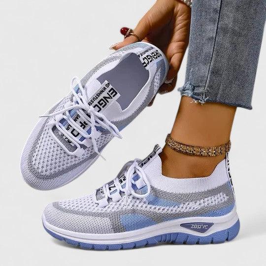 A woman lacing up light, breathable orthopaedic sneakers before a walk.