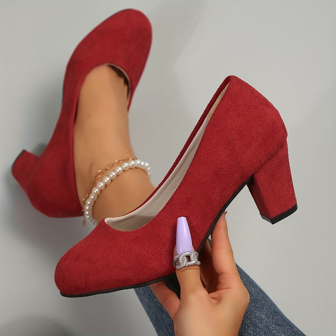 A woman in sturdy block heels standing comfortably and confidently through a long day.