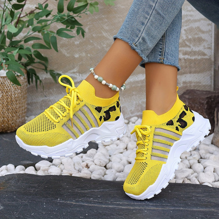 A woman walking in light, breathable comfort sneakers on a warm day.