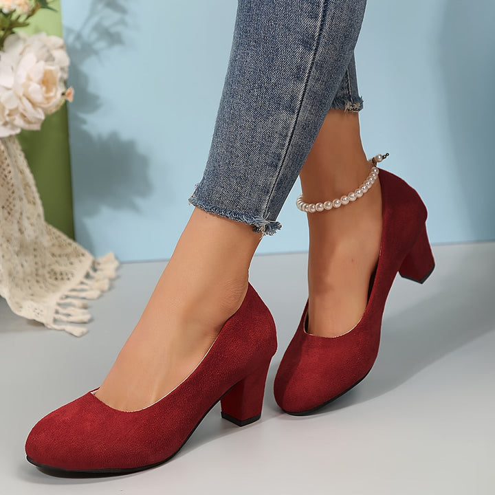 A woman in sturdy block heels standing comfortably and confidently through a long day.