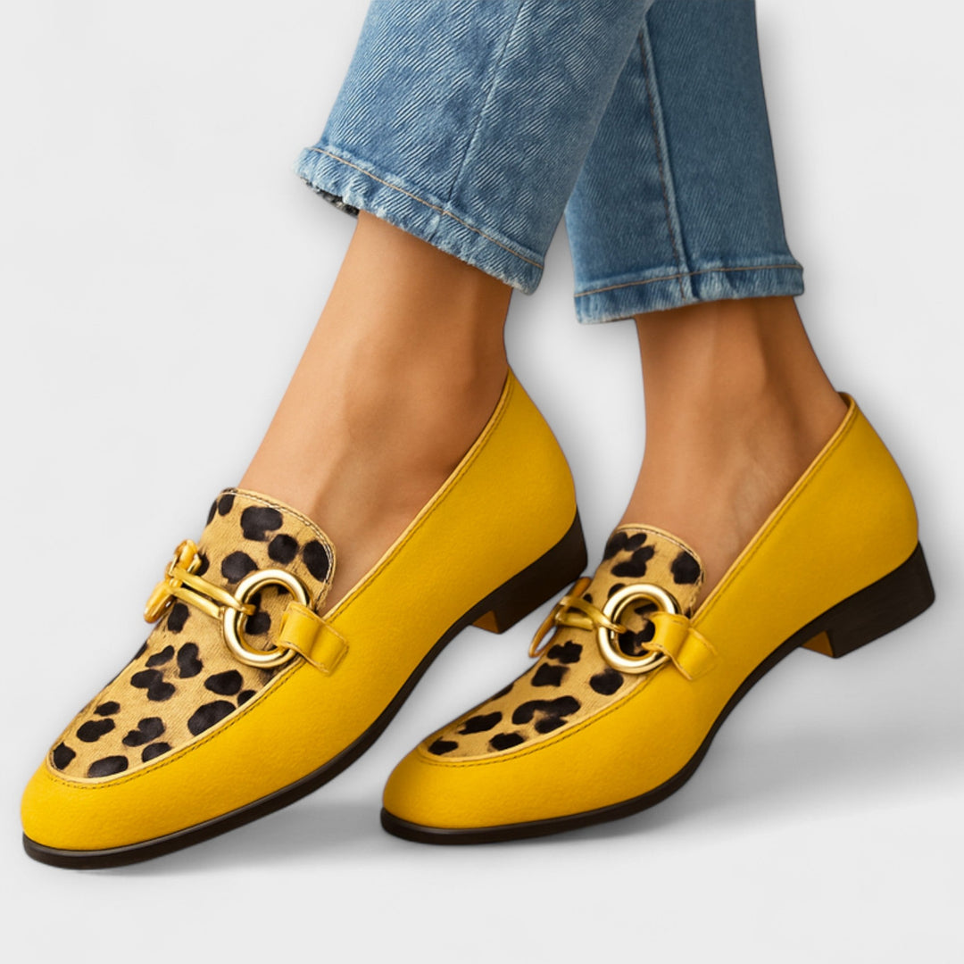 A woman wearing detailed slip-on loafers, finished with fine accents, on an everyday outing