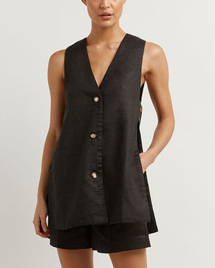 A woman wearing a sleeveless buttoned two-piece set
