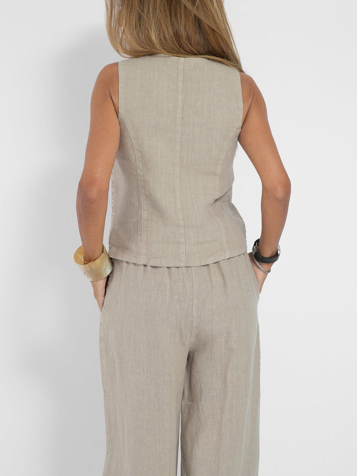 A woman wearing a tailored waistcoat with flowing wide-leg pants